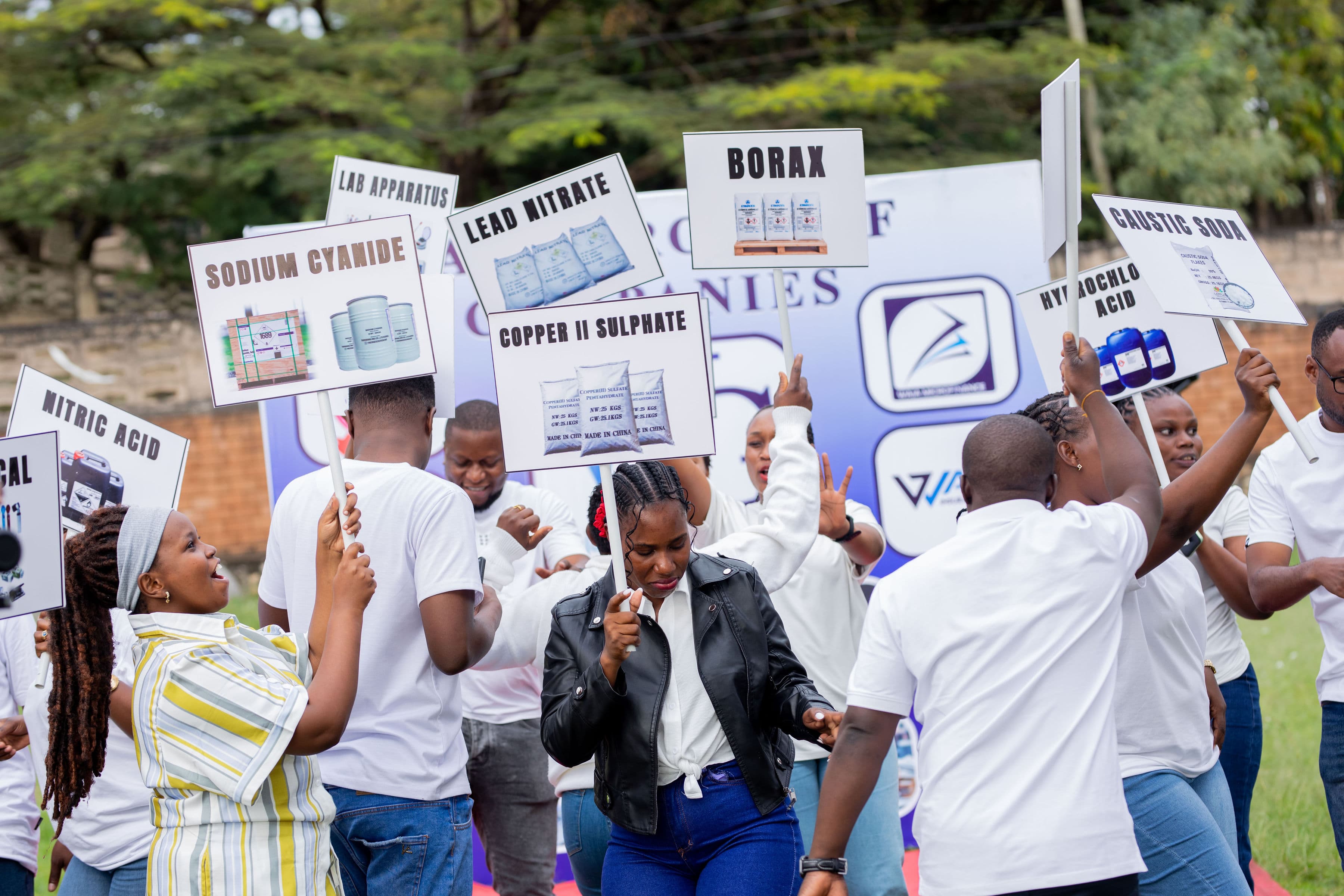 Waja General team members holding product signs during a fun team moment