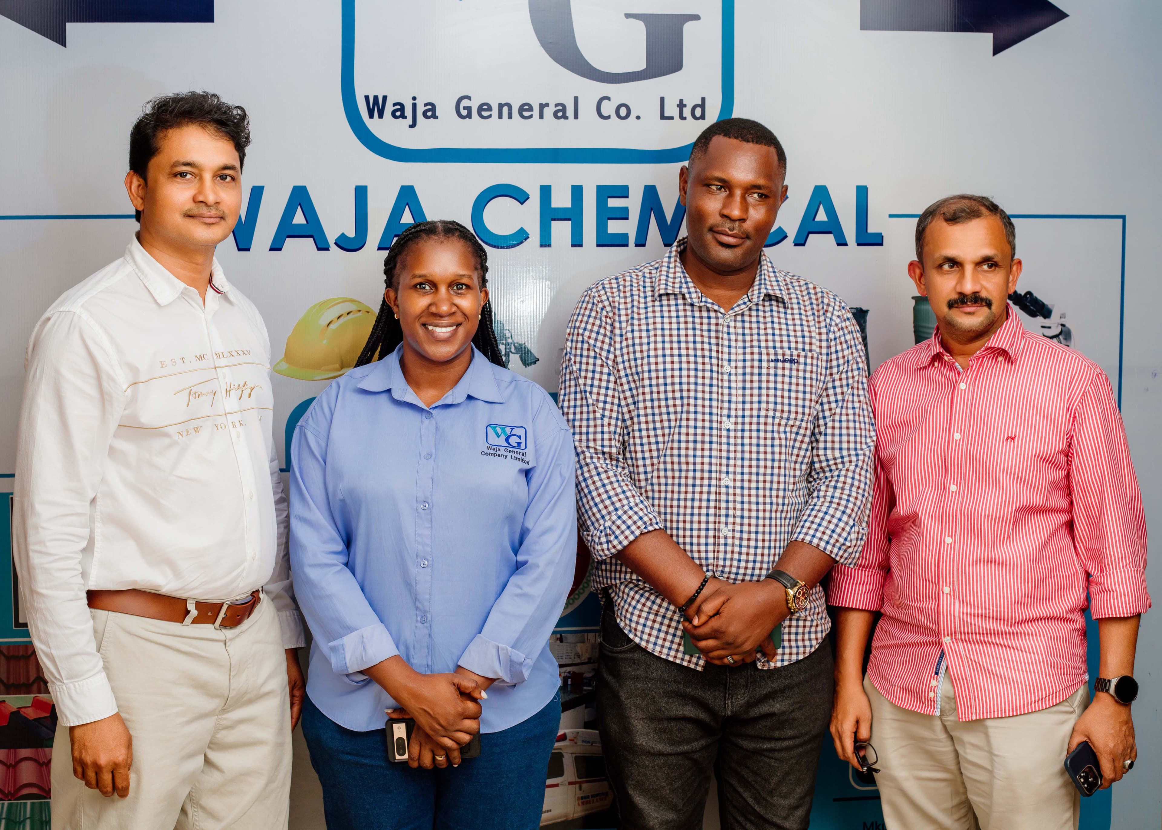 Waja General manager standing with partners at Waja Chemicals